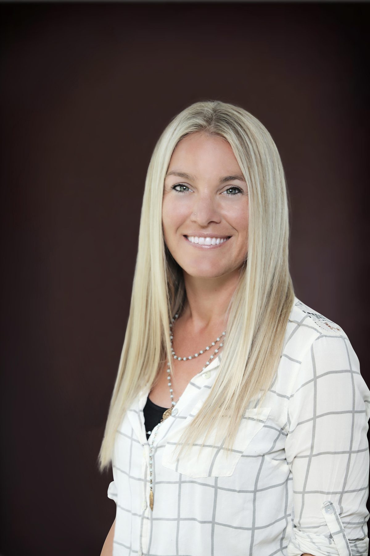 Professional headshot against a dark backdrop